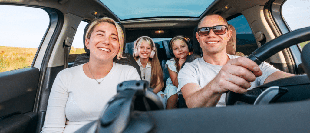 Road Trip Inspection by C&M Auto Service, Inc. in Morgan Hill, CA. Image of a happy family with their dog in the car, ready for a safe and enjoyable summer road trip.