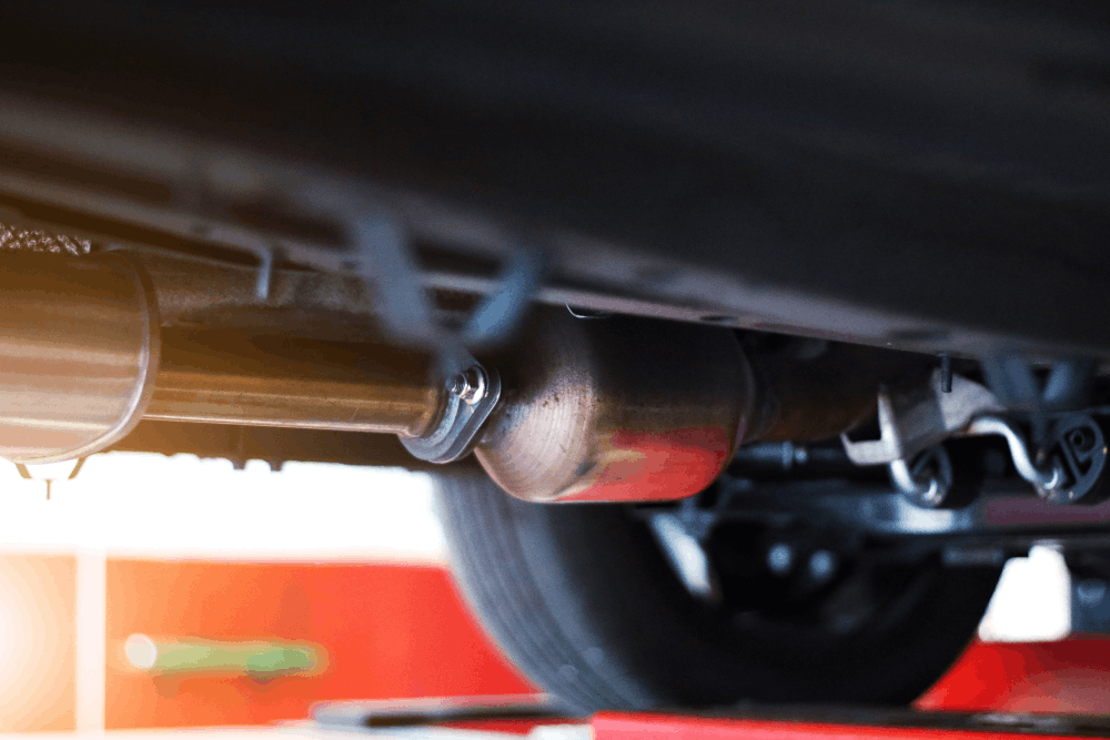 Catalytic converter, auto repair in Morgan Hill, CA at C&M Auto Service. Image of a vehicle undercarriage showing exhaust piping and components during inspection to support proper emissions and reliable performance.